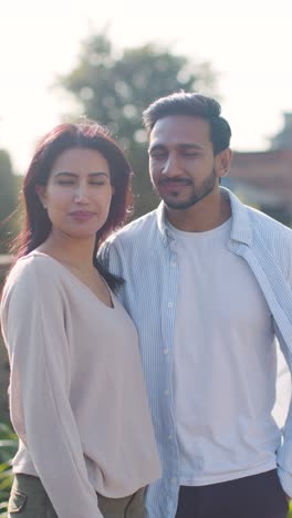 Vertical-Video-Portrait-Of-Muslim-Couple-On-Date-Walking-Through-City-Park-Together